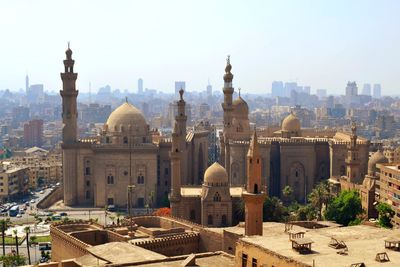 An ancient mosque in cairo with an old architecture around it 