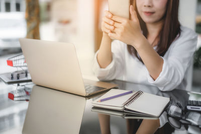 Low angle view of woman using laptop on table