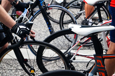 Cropped image of bicycles parked on roadside