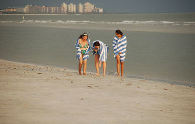 Full length of boy playing on sand at beach