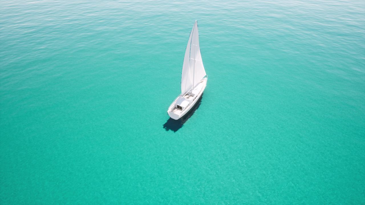 HIGH ANGLE VIEW OF SAILBOAT ON SEA