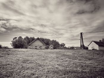 Houses on field against sky