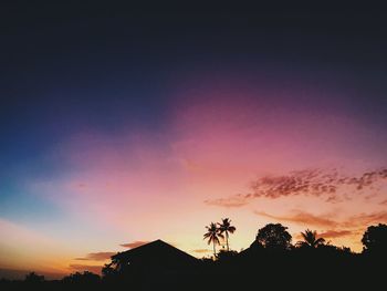 Low angle view of silhouette trees against romantic sky