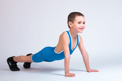 Full length of happy baby boy against white background