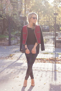 Portrait of young woman standing in city