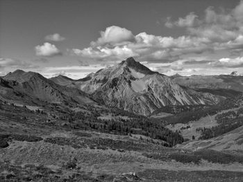 Scenic view of mountains against cloudy sky