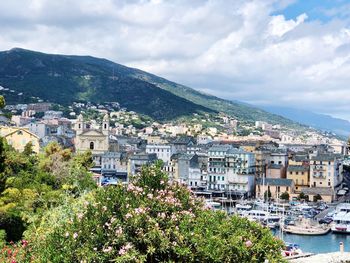 View of townscape by sea against sky