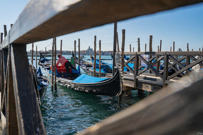 Sailboats moored in sea against sky in venice