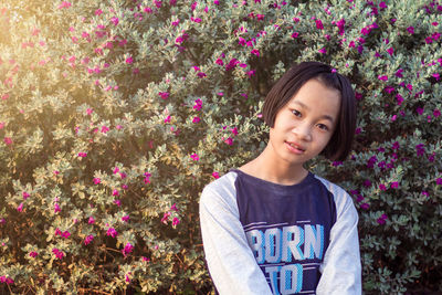 Portrait of smiling girl against plants