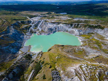 High angle view of landscape, including blue-green body of watrr
