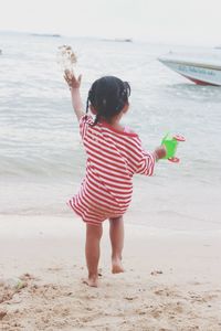 Full length of woman standing on beach