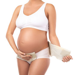 Midsection of woman standing against white background