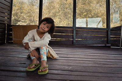 Full length of woman sitting outdoors