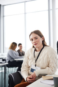 Portrait of young businesswoman sitting at desk