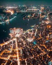 Aerial view of illuminated buildings in city at night