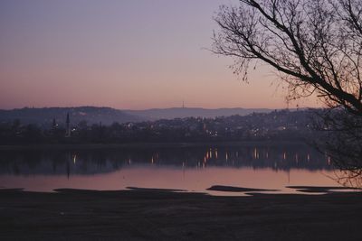 Scenic view of lake against sky at sunset