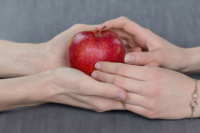 Close-up of hand holding strawberries