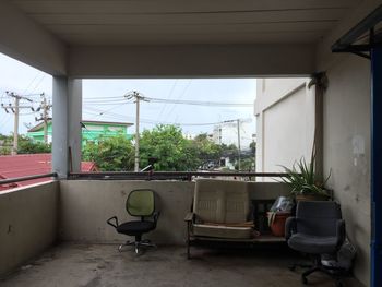 Potted plants by window against sky