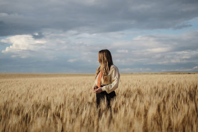 Full length of man standing on field against sky