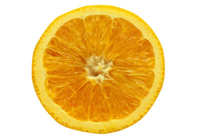 Close-up of orange slice against white background