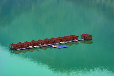 High angle view of boat floating on lake against building