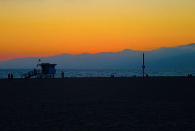 Scenic view of beach against sky during sunset