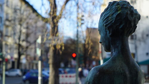 Close-up of statue against trees in city