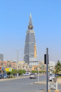 View of city street and buildings against sky