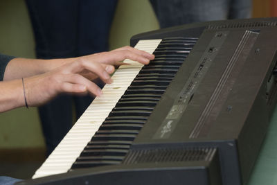 Midsection of man playing piano