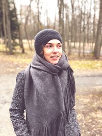 Smiling woman wearing warm clothing during winter