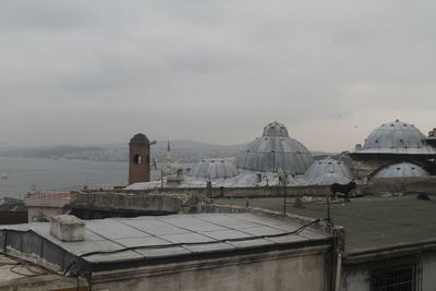 Houses against cloudy sky