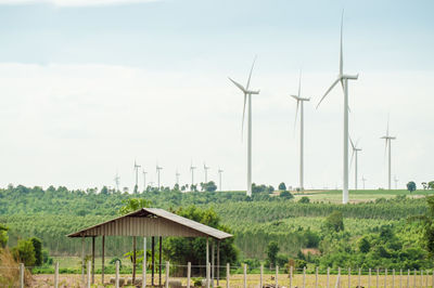 Windmill on field against sky