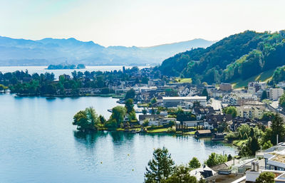 Scenic view of river and townscape against sky