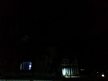 Low angle view of illuminated building against sky at night