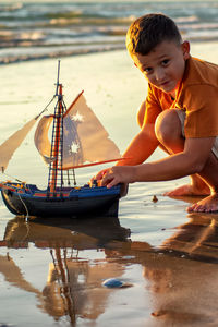Boy in boat on shore