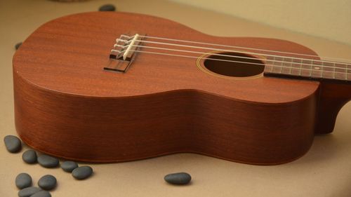 Close-up of guitar and pebbles on table