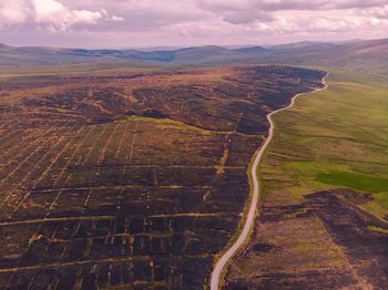 High angle view of land against cloudy sky