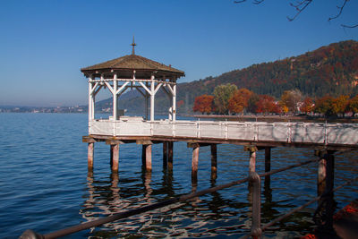 Pier over lake against clear sky