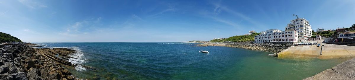 Panoramic view of sea against blue sky