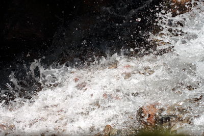 Full frame shot of water splashing against black background