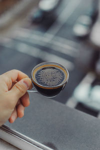 Person holding coffee cup