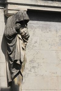 Statue of buddha against wall