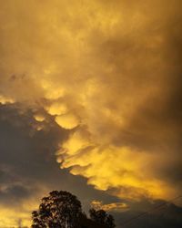 Low angle view of cloudy sky at sunset