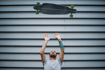 A boy launches skateboard up