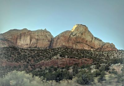 Rock formations on landscape against clear sky