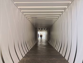 Rear view of people walking in corridor