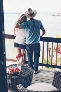 Rear view of couple standing at sea shore