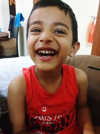 Portrait of smiling boy sitting at home