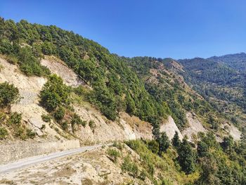 Scenic view of mountains against clear blue sky