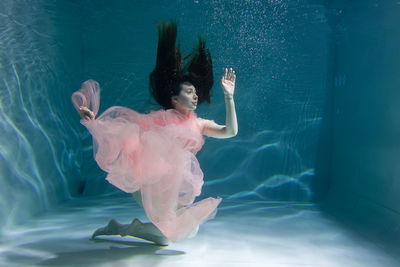 Woman dancing in swimming pool